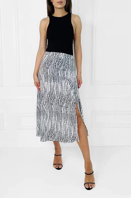 EDEN BLACK & WHITE POLKA DOT MIDI SKIRT WITH AN ASYMMETRICAL HEMLINE